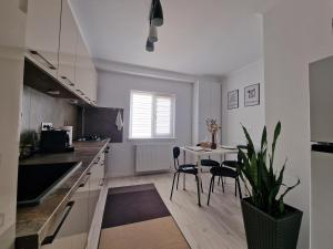 a kitchen with a table and a dining room at Elite Apartment Onesti in Onești