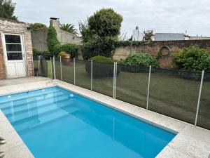 a swimming pool with a fence around it at Casa Tradicional del Barrio de la Estación in Tandil