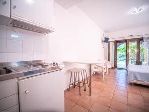 a kitchen with a sink and a table in a room at St George's House in Potistika