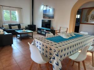 a living room with a table with chairs and a couch at Villa enseñat ETV04085 in Pollença