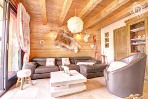 a living room with a couch and a table at La Cabane du Lys in Les Déserts