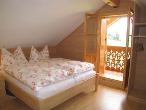 a bedroom with a bed with a ladder and a window at Ferienhütte Wolfgangsee in St. Wolfgang