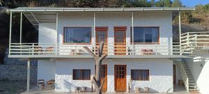 a white house with a tree in front of it at Arthaat by T&C Living in Chakrāta