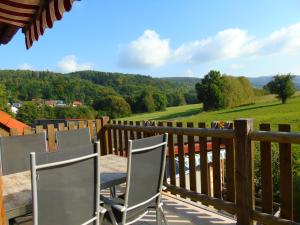 a deck with chairs and a view of the mountains at Ferienwohnung Csilla in Unterweid +44 photos