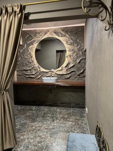 a bathroom with a stone wall and a mirror at Sauna Dharma Stay Self check in in Telšiai +5 photos