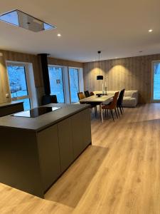 a kitchen and living room with a table and chairs at Lofoten Seaview apartment in Vestvågøya