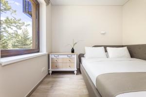 Postel nebo postele na pokoji v ubytování Lagūna - Šventoji
