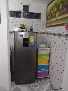 a kitchen with a refrigerator in a room at Posada for Living in San Andrés