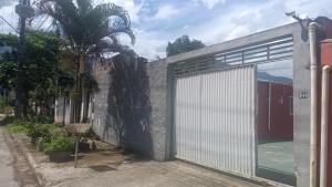 a white garage door on the side of a building at Viver Massaguaçu Suíte 2 in Caraguatatuba