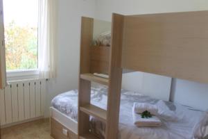 a bedroom with a bunk bed with a mirror at Casa en Empordà con piscina grande propia in Báscara +29 photos