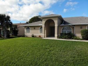 a large house with a green lawn in front of it at The Elegant Suite in Shared House in Cape Coral