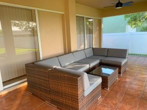 a wicker couch and coffee table on a porch at The Elegant Suite in Shared House in Cape Coral