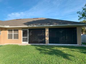 a house with large sliding glass doors in a yard at The Elegant Suite in Shared House in Cape Coral