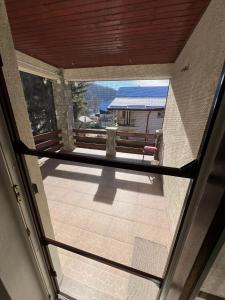an empty balcony with a view of a house at RED HOUSE Sinaia in Sinaia +25 photos