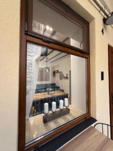 a window with a view of a dining room at MMA's Apartment - 1 min de Târgul de Crăciun Sibiu in Sibiu
