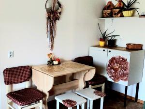 a room with a table and chairs and a cabinet at Ciemos pie Ingas in Smiltene +7 photos