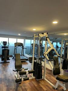 a gym with several tread machines in a room at Luxury condo with rooftop pool! in Islamabad