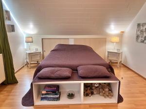 a large bed in a room with two tables at Les Pierris in La-Roche-en-Ardenne