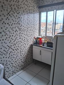 a small kitchen with a sink and a window at Casa da laje in Sao Paulo