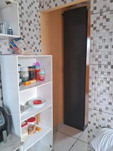 a white refrigerator with its door open in a kitchen at Casa da laje in Sao Paulo