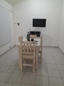 a desk with a computer and a chair in a room at Casa en La Punta San Luis in La Punta
