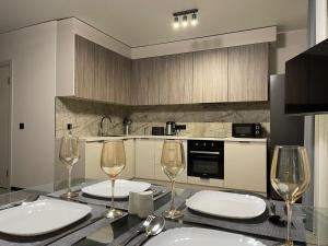 a kitchen with a table with wine glasses on it at Uzhhorod Apartment Lux in Uzhhorod +3 photos