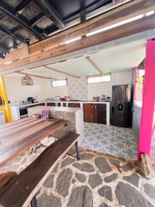 a large kitchen with a wooden table and a counter at Mojarra Beach Casa Privada-Santa Veronica in Salina de Rey