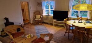 a living room with a table and chairs and a television at Lillåns B&B in Örebro