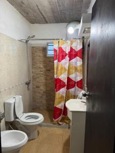 a bathroom with a toilet and a sink at Casa en San Luis in La Floresta