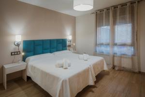 A bed or beds in a room at La Olma