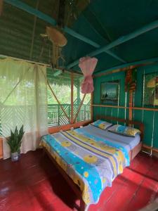 a bedroom with a large bed in a room at Hostal Búho Amazonas tours in Leticia