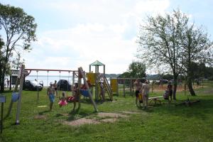 a group of people standing around a playground at Atpūtas komplekss " Ezerkrasti" in Čornaja