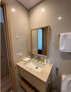 a bathroom with a sink and a mirror at 2BR Family Apartment Spectacular Scenery in Da Nang