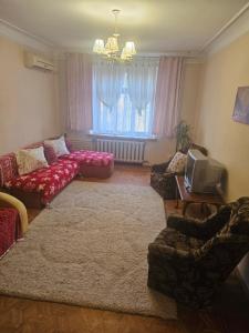 a living room with two couches and a tv at 2 комнатные аппартаменты на бульваре Пушкина in Kremenchuk
