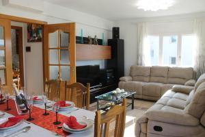 a living room with a table and a couch at Casa en Empordà con piscina grande propia in Báscara