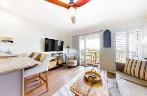 a living room with a couch and a tv at Pineapple Palms at the Sea Cabins in Isle of Palms