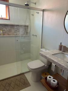 a bathroom with a shower and a toilet and a sink at Diamantino 08 Mucugê Luxo in Mucugê +39 photos