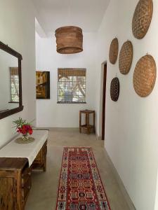 a living room with a table and a rug at Sandy Feet Retreat in Malindi