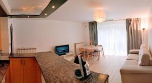 a kitchen and living room with a couch and a table at La Jara in Fuenmayor