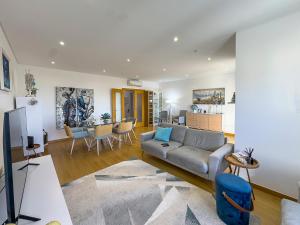 a living room with a couch and a table at Vibing & Liming Ericeira in Ericeira