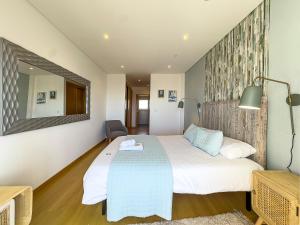 a bedroom with a bed and a mirror at Vibing & Liming Ericeira in Ericeira