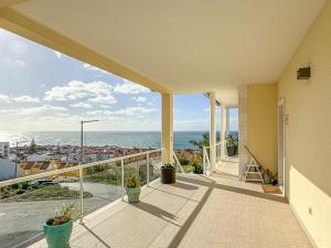 a balcony with a view of the ocean at Vibing & Liming Ericeira in Ericeira