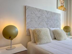 a bedroom with a bed with two lamps on it at Vibing & Liming Ericeira in Ericeira