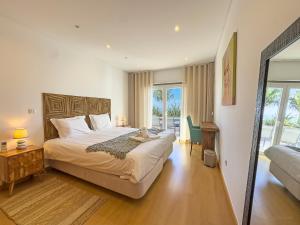 a bedroom with a bed with a teddy bear on it at Vibing & Liming Ericeira in Ericeira