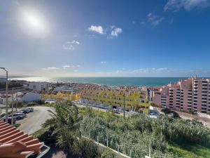 a view of a city with buildings and the ocean at Vibing & Liming Ericeira in Ericeira