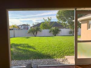 a view of a yard from a sliding glass door at The Elegant Suite in Shared House in Cape Coral
