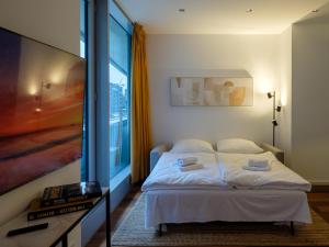 ein Schlafzimmer mit einem Bett und einem großen Fenster in der Unterkunft Come2Stay Hafencity - Marco Polo Tower 2 in Hamburg