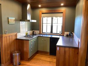 a kitchen with a sink and a counter top at Fantail Cottage in Hurunui