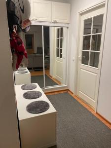 a living room with a white counter with two gray cushions at Hiihtäjänkuja 5A4, Levi in Levi +31 photos