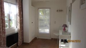 a room with a door and a table and a window at villa des oliviers in Le Tignet